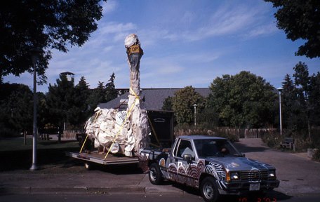 truck moving big swan sculpture