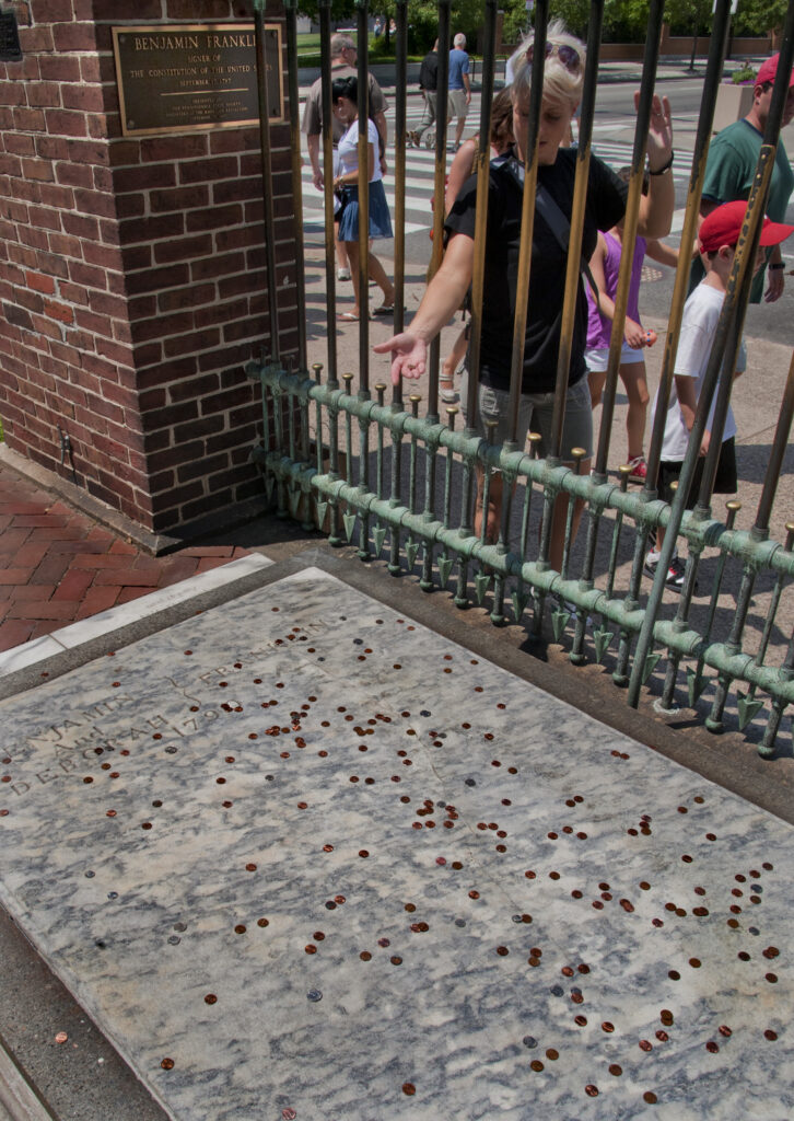 Why do Philadelphians throw pennies onto Benjamin Franklin’s grave?