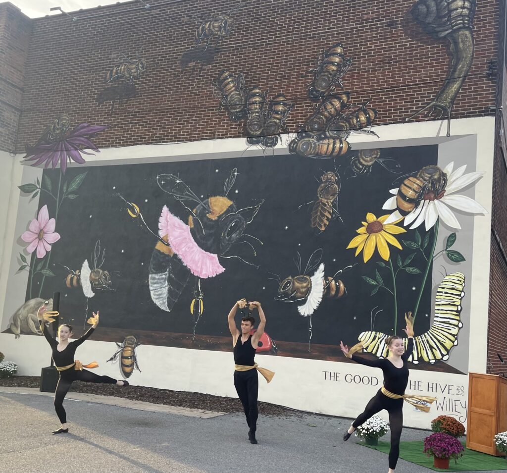 ballet dancers in front of mural