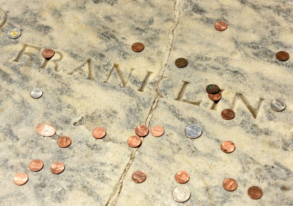 Why do Philadelphians throw pennies onto Benjamin Franklin’s grave?