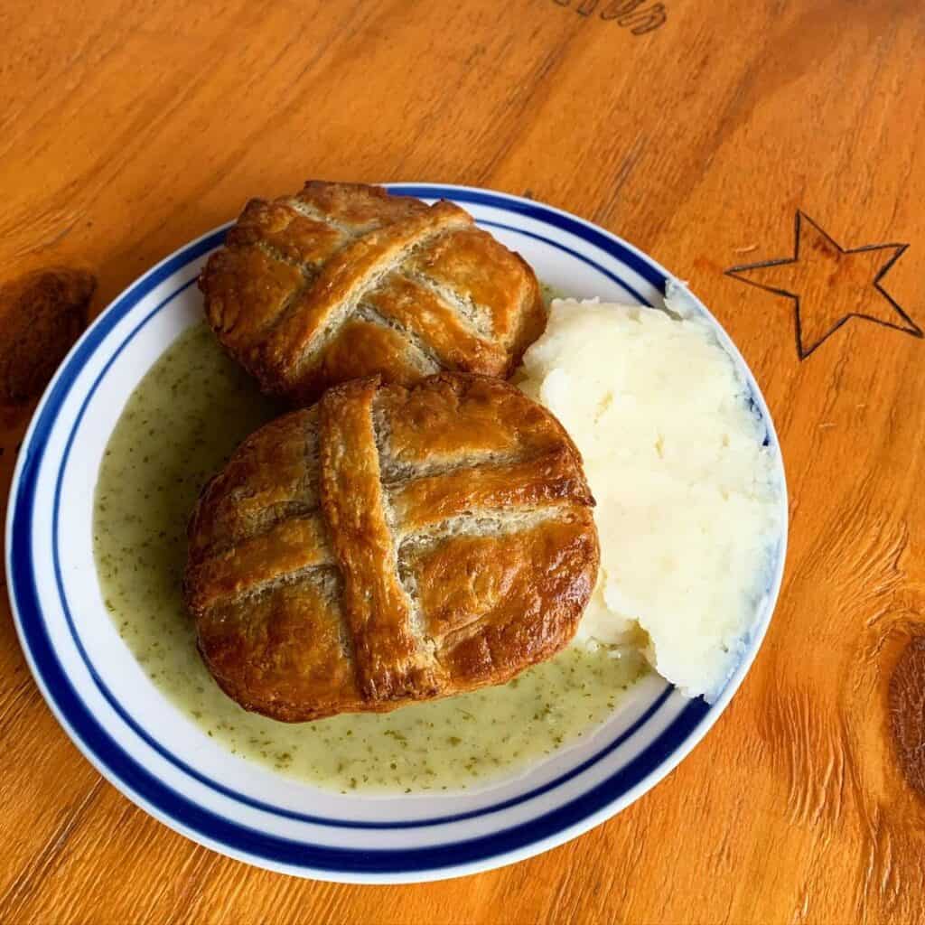 small meat pie with mash on plate