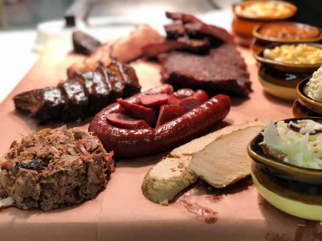 a spread of bbq meats and sides