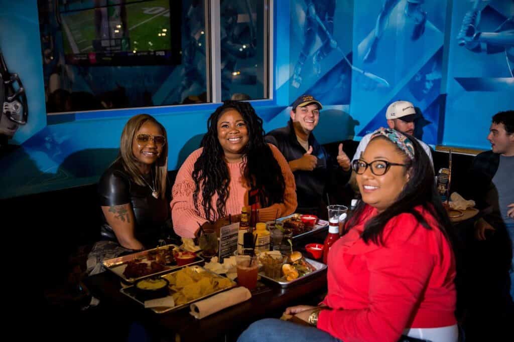 group of diners smiling in bar