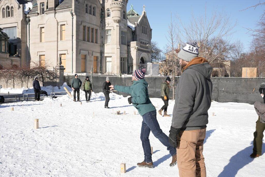 men playing kubb in the snow