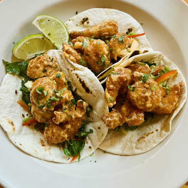 three bang bang shrimp tacos
