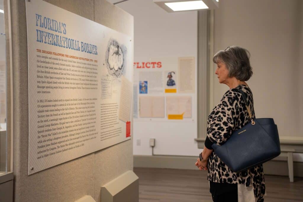 woman looking at Florida Historic Capitol Museum exhibit