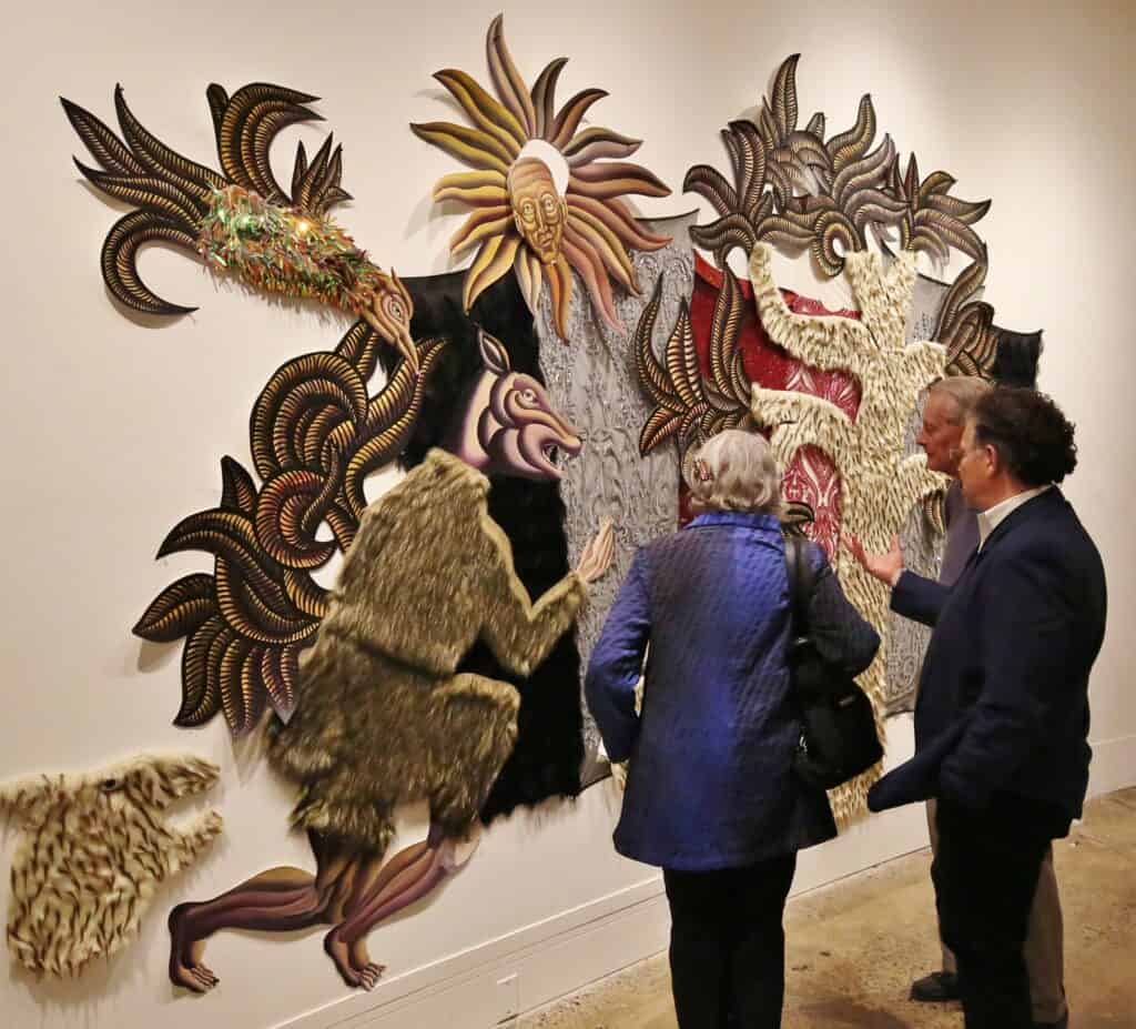 three older people looking at art