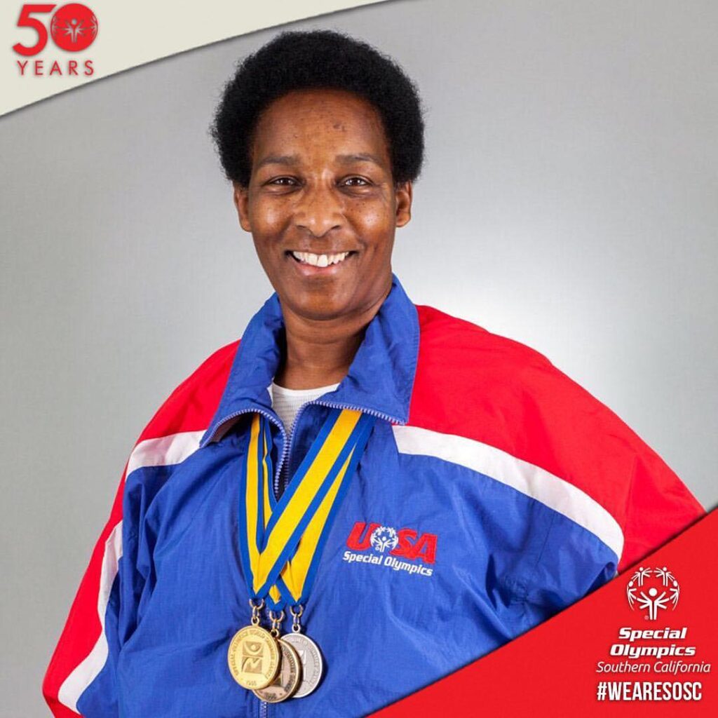 Loretta Claiborne smiling with medals