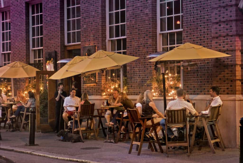 people dining under umbrellas outside