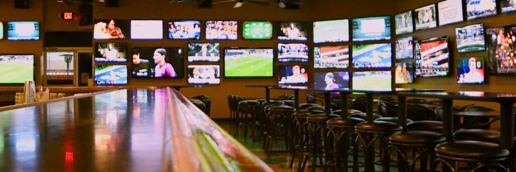wall of TVs in bar