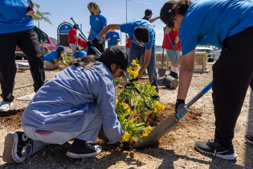 Earth Week participants planting flowers City of Avondale x